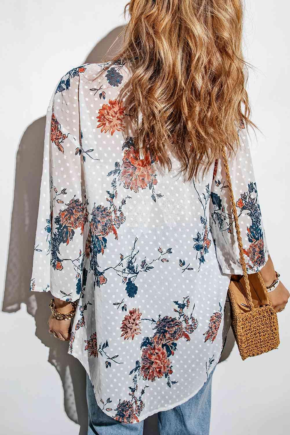 a woman with long hair wearing a floral blouse