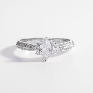 a white gold ring with a pear shaped diamond
