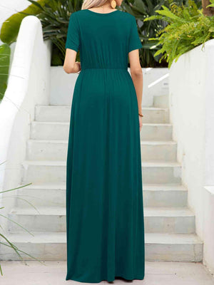 a woman in a green dress standing on steps
