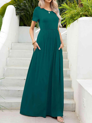 a woman in a green dress standing on steps