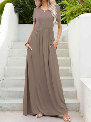 a woman in a long dress standing on steps