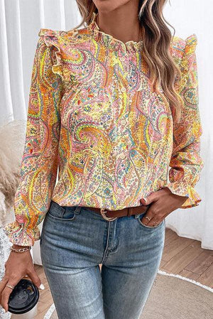 a woman wearing a colorful blouse and jeans