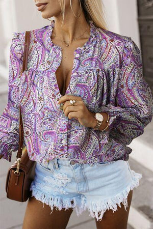 a woman wearing a purple shirt and denim shorts