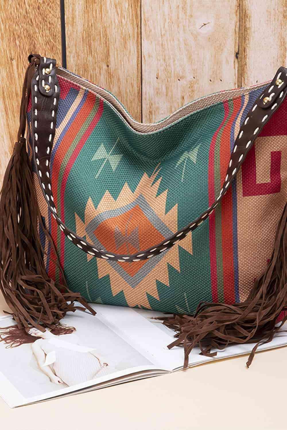 a purse sitting on top of a table next to a book