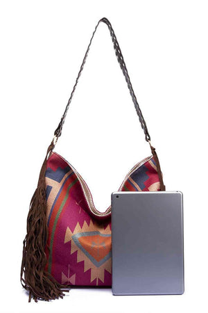 a purse with a laptop on top of it