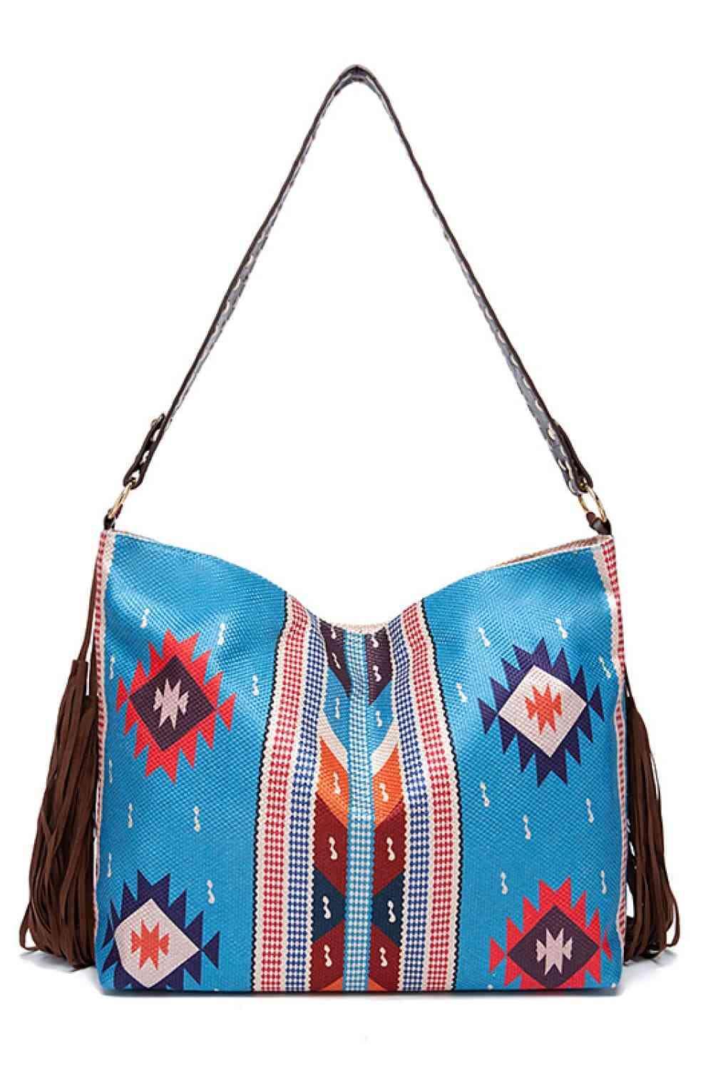 a blue purse with a tasselled handle