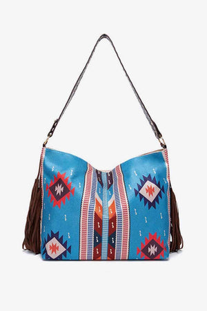 a blue purse with a tasselled handle