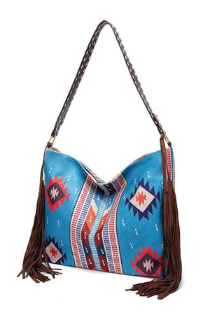 a blue purse with a fringed handle