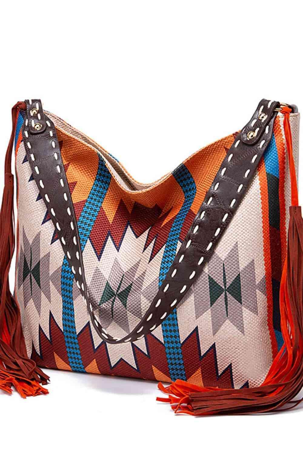 a multicolored bag with a tasseled handle