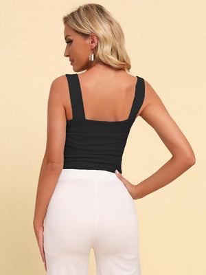 a woman wearing a black top and white pants