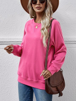 a woman wearing a pink sweater and hat