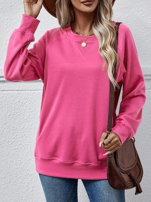 a woman wearing a pink sweater and hat