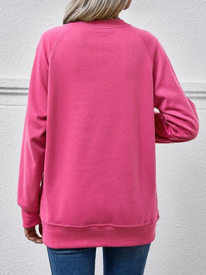 a woman wearing a pink sweatshirt and jeans