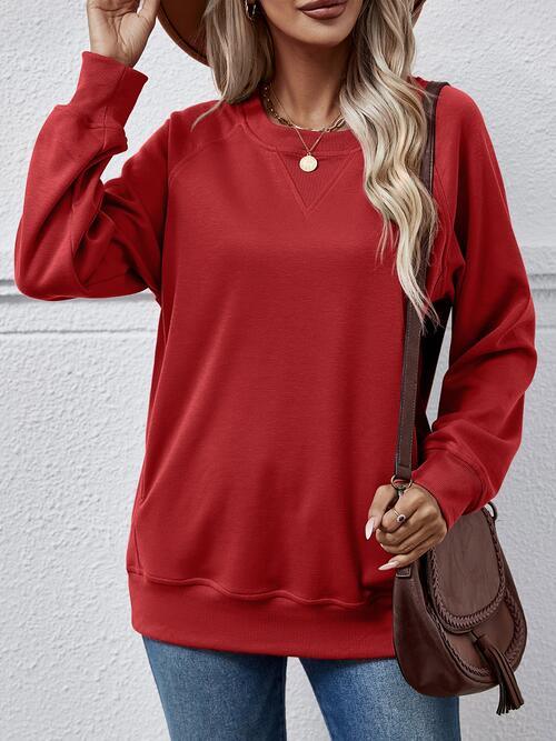 a woman wearing a red sweater and hat