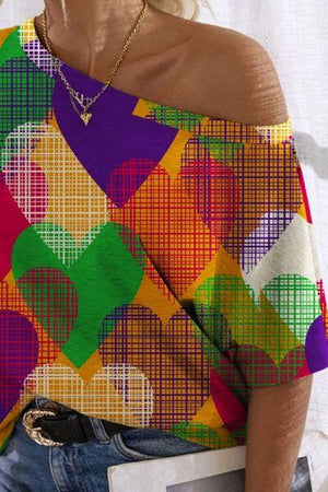 a woman wearing a colorful shirt and jeans