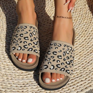 a close up of a person wearing leopard print sandals