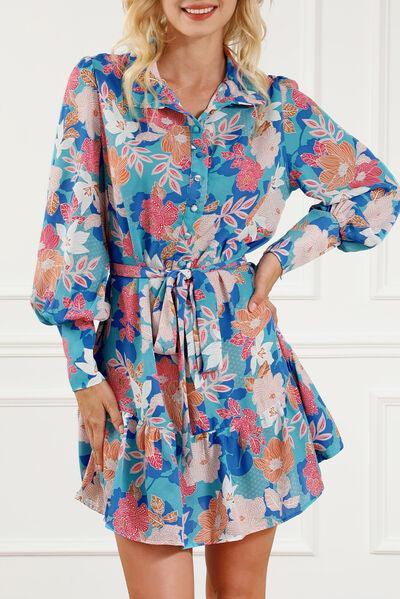 a woman wearing a blue and pink floral shirt dress