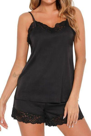 a woman wearing a black top and shorts