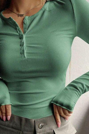 a woman in a green shirt is posing for a picture