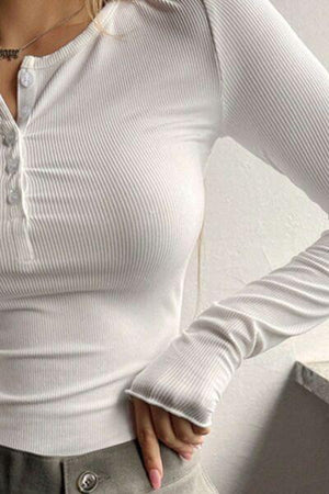 a woman wearing a white shirt and grey pants