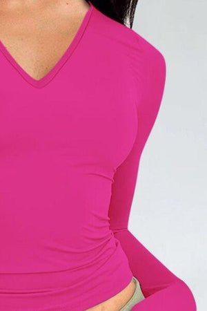 a woman in a pink shirt is posing for a picture