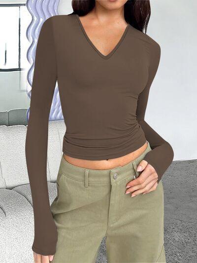 a woman in a brown shirt and khaki pants