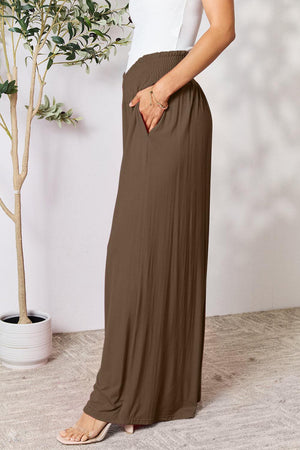 a woman in a white top and brown skirt