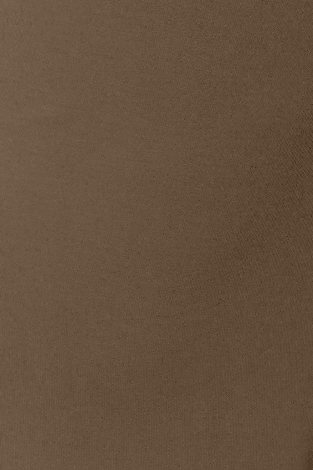 a man in a brown shirt is holding a cell phone