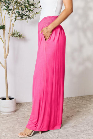 a woman in a white top and pink skirt