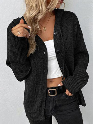 a woman wearing a black cardigan sweater and jeans