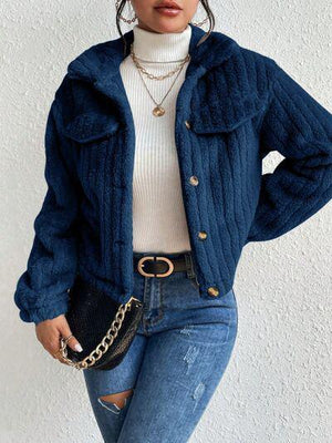 a woman wearing a blue jacket and jeans