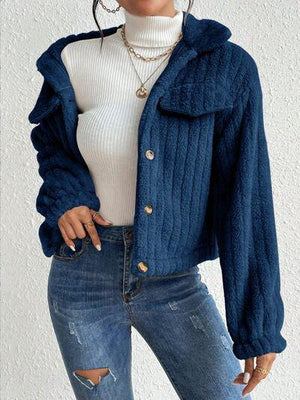 a woman wearing a blue jacket and jeans