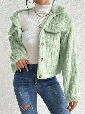 a woman wearing a green jacket and ripped jeans