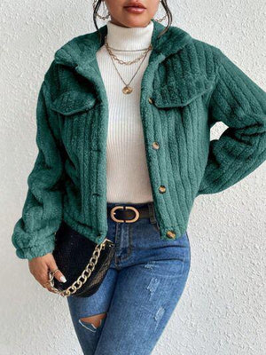 a woman wearing a green jacket and jeans