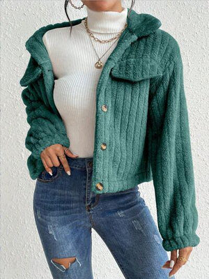 a woman wearing a green jacket and ripped jeans