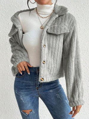a woman wearing ripped jeans and a sweater