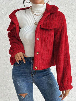 a woman wearing a red jacket and ripped jeans