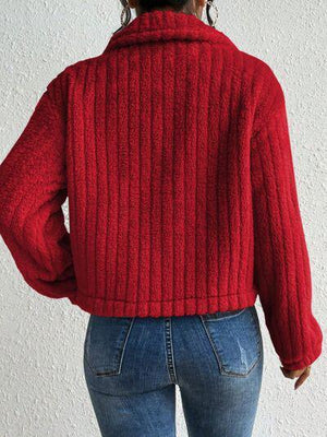 a woman wearing a red sweater and jeans