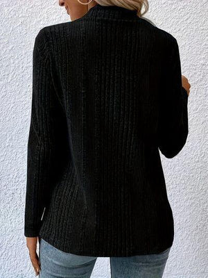 a woman wearing a black sweater and jeans