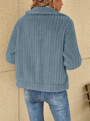 a woman wearing a blue sweater and jeans