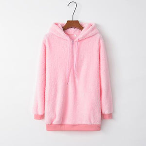a pink teddy bear hoodie hanging on a hanger
