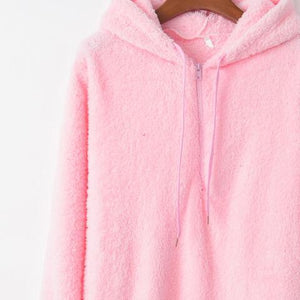 a pink hoodie is hanging on a hanger
