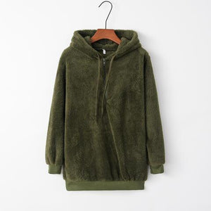 a green jacket hanging on a hanger