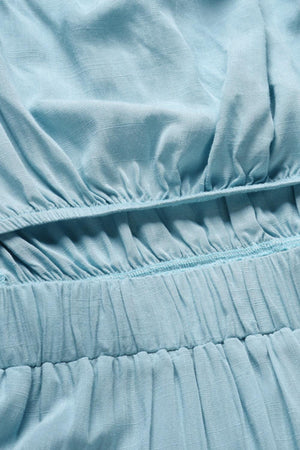 a close up of a blue dress with ruffles