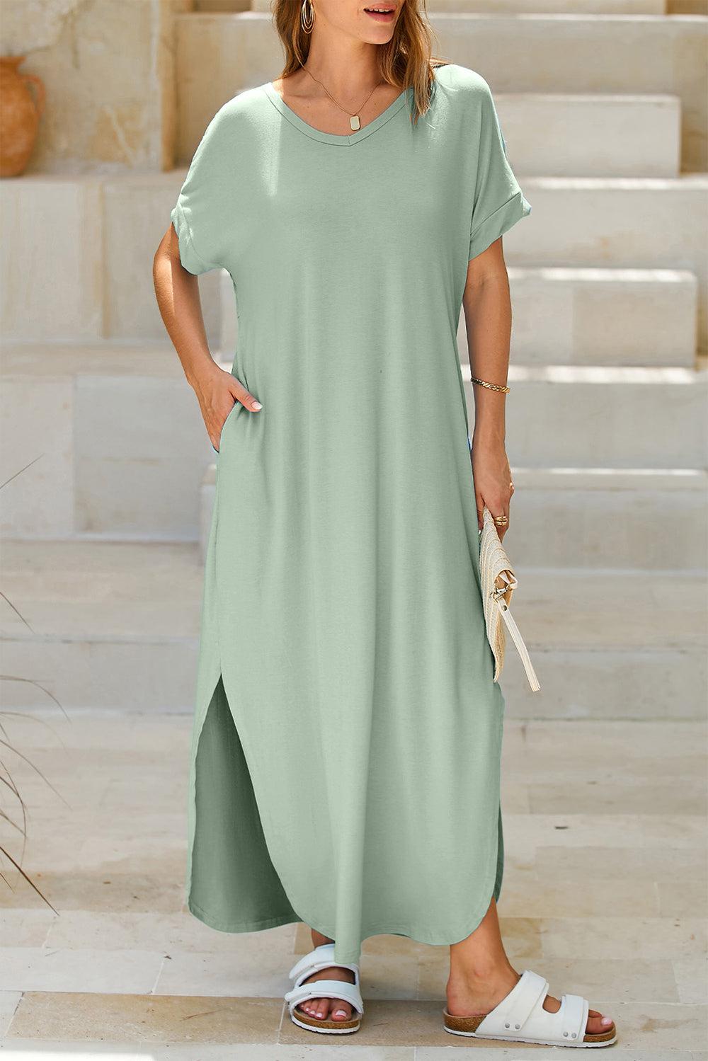 a woman in a green dress standing in front of some steps