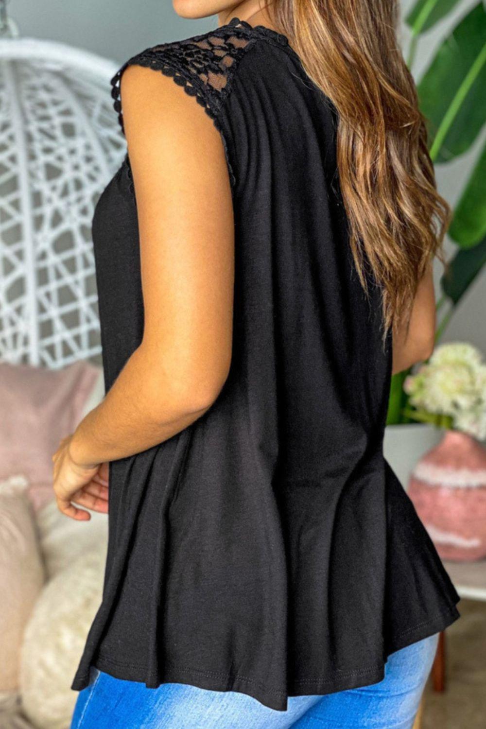 a woman wearing a black top and blue jeans