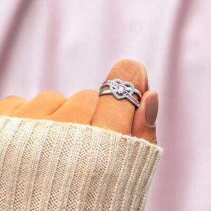 a woman's hand with a ring on it