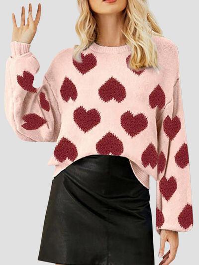 a woman wearing a pink sweater with hearts on it