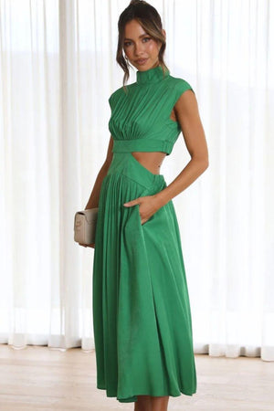 a woman in a green dress posing for a picture