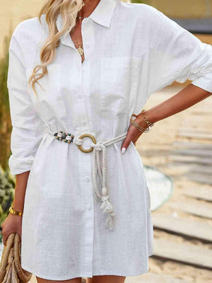 a woman wearing a white shirt dress with a belt